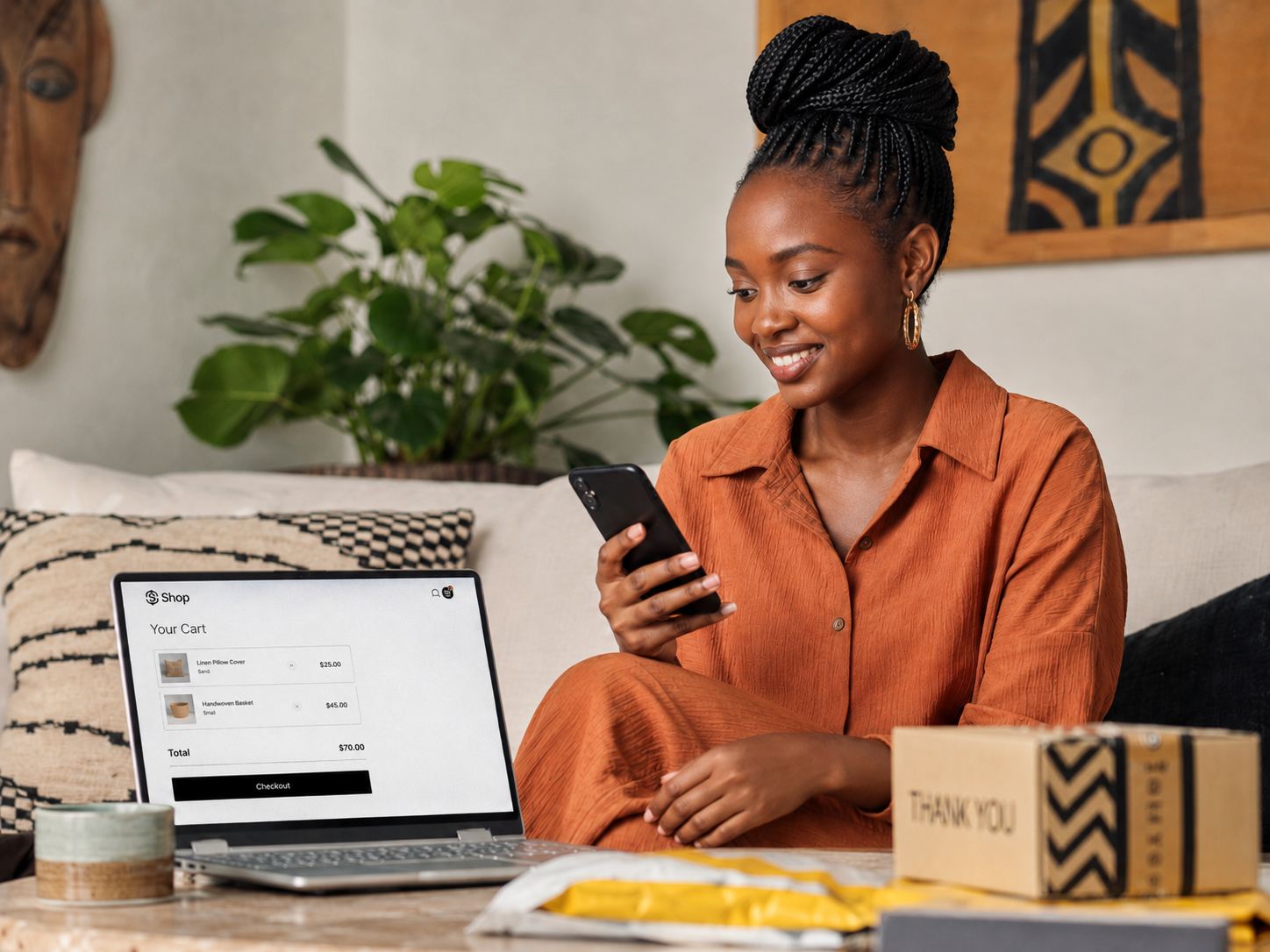 A customer shopping online with her cart open on a laptop